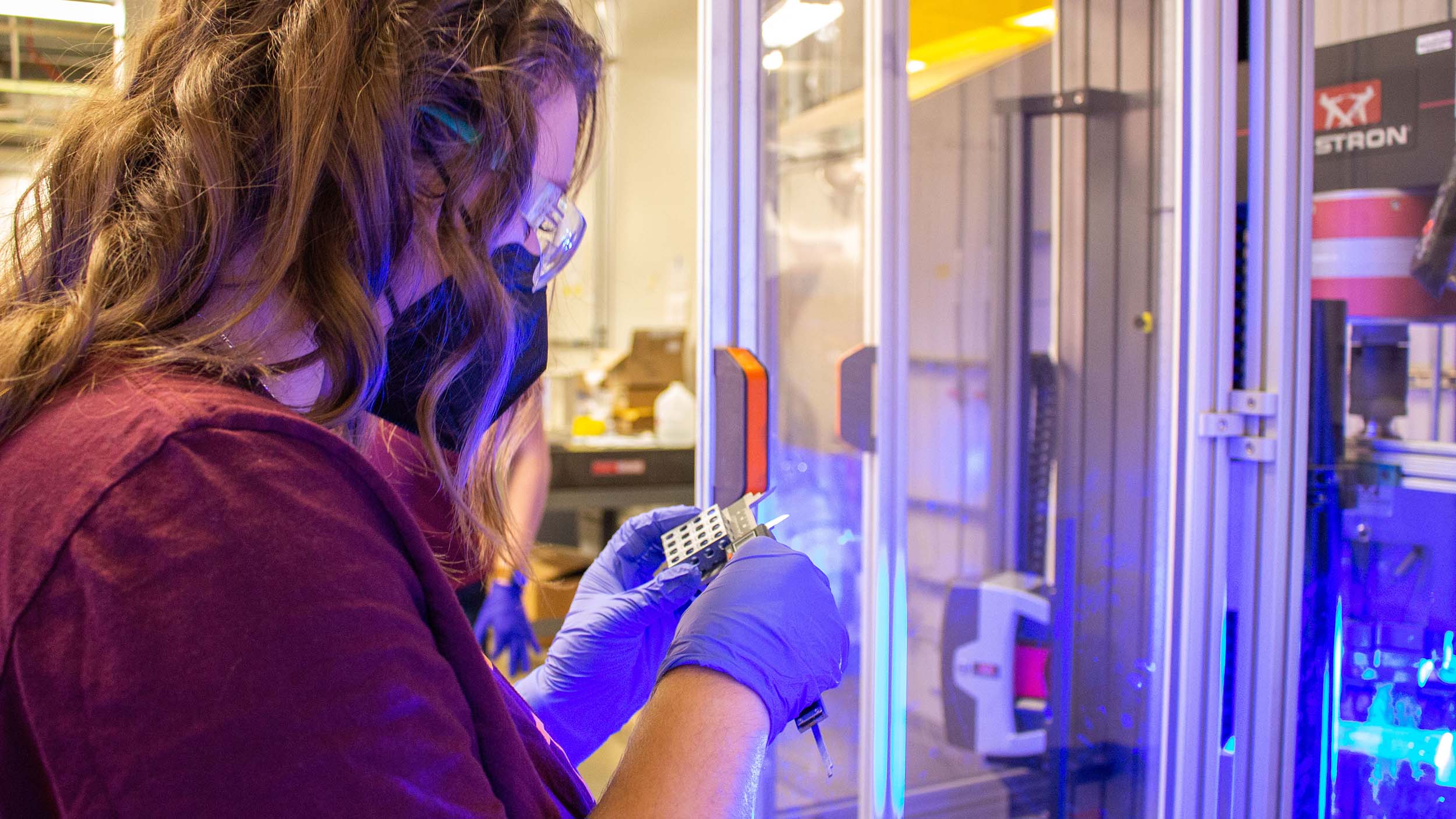 An ASU manufacturing engineering student measures an object produced by additive manufacturing.