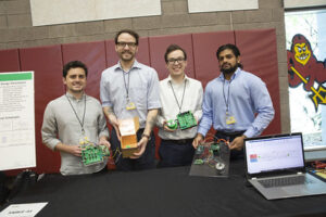 group at innovation showcase with circuit boards 