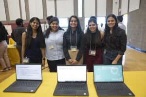 group pic at innovation showcase with laptops