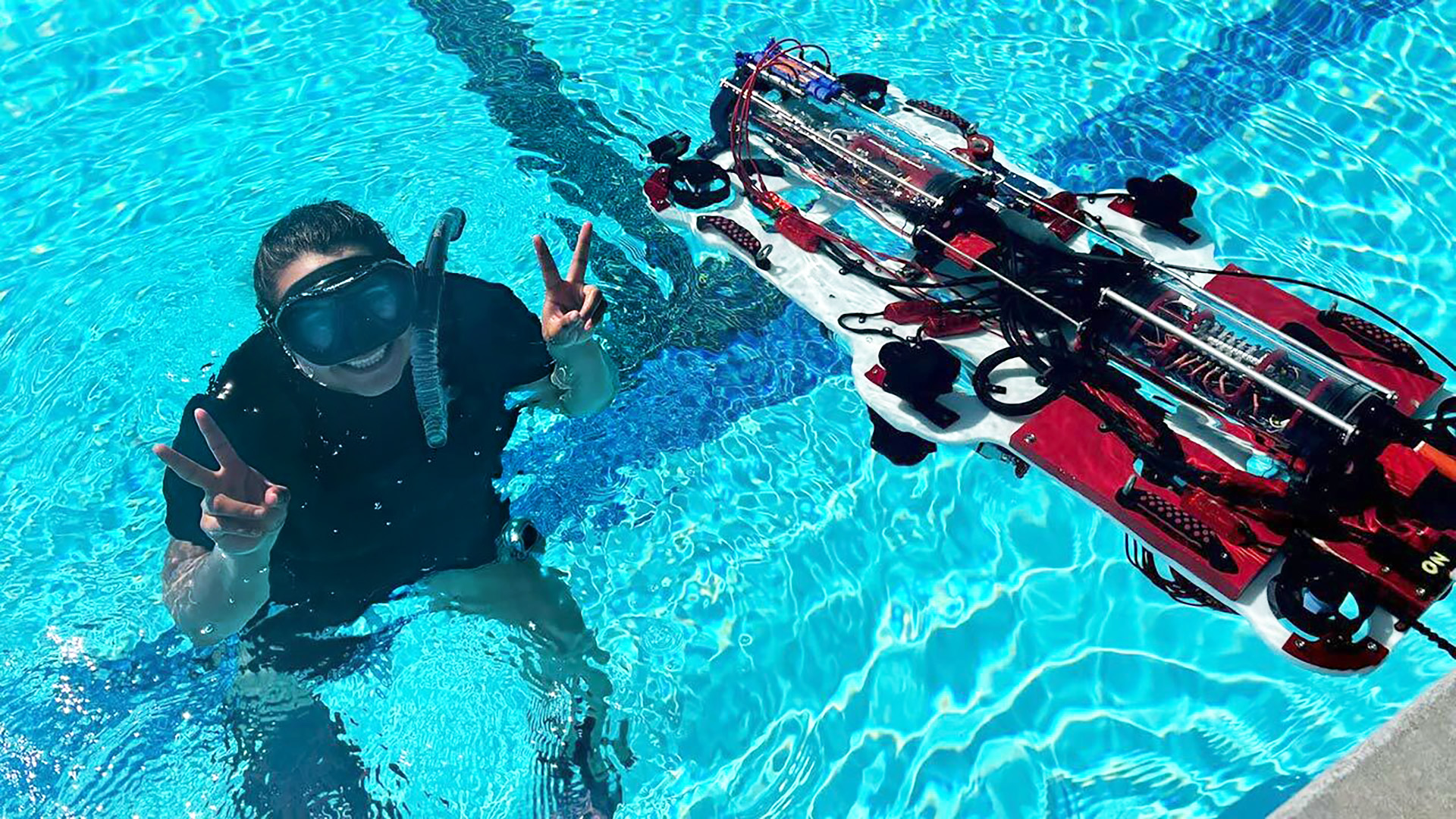 student in the water with robot