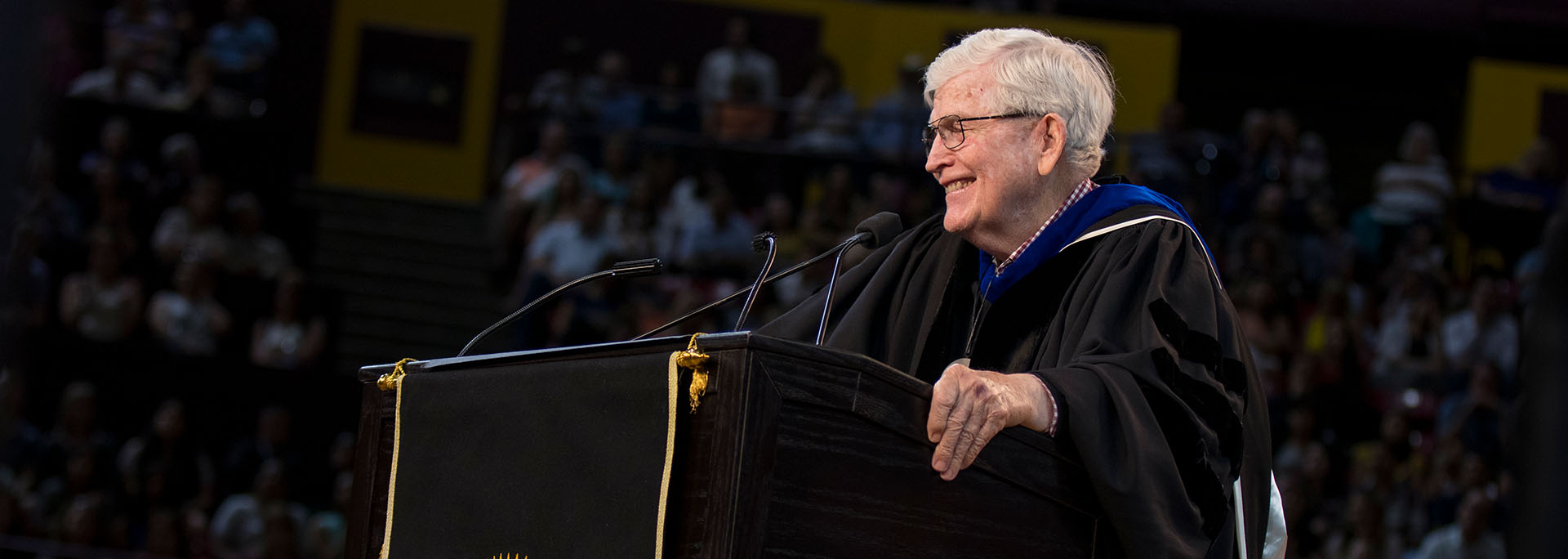 FSE-Spring18-Gold-Convocation-MAC0609a_uds-lg-hero Ira A. Fulton stands at the podium during the ASU Engineering Convocation ceremony, smiling while he addresses the crowd.